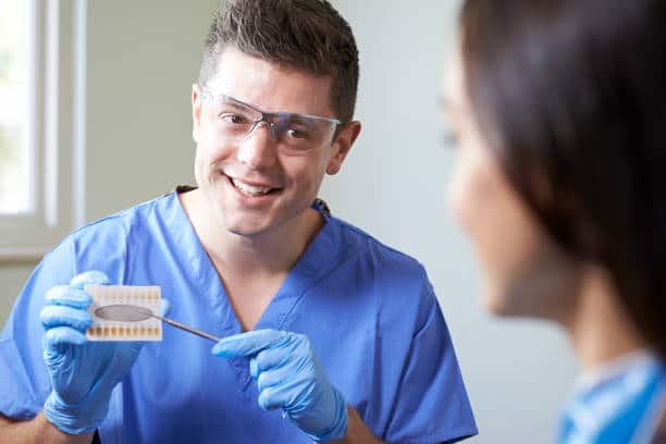 Dentist Giving Woman Advice On Cosmetic Teeth Whitening